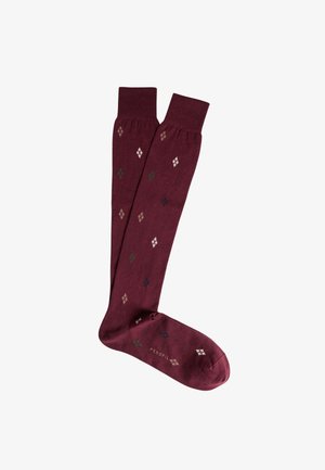 Calze color bordeaux al ginocchio con un motivo a diamante in verde, blu e crema. Texture morbida; parte superiore aderente; finitura liscia; nome del marchio "PEROFIL" sulla suola.