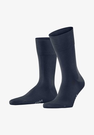 Calzini di un blu navy scuro realizzati in un materiale morbido ed elastico. Presentano orli a coste, una texture liscia e una zona della punta rinforzata.