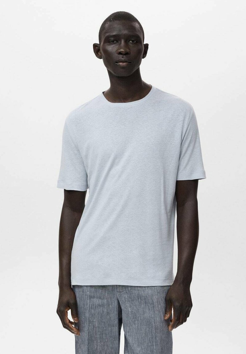 Light gray short-sleeve t-shirt made of soft fabric with a round neckline, paired with textured gray pants. Simple, minimal design.