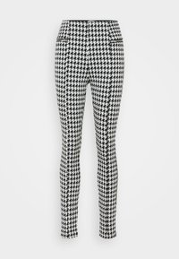Zwart-wit houndstooth-patroon legging met een getailleerd ontwerp, voorzien van zijzakken met rits en een elastische tailleband.