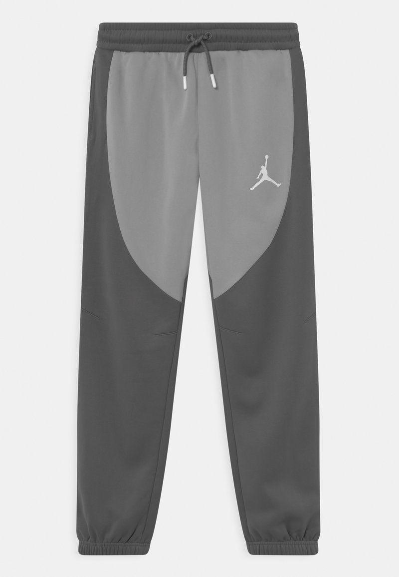Dwukolorowe szare dresy sportowe z elastycznym paskiem w talii, sznurkiem i mankietami na kostkach, z białym logo Jumpman na prawej udzie.
