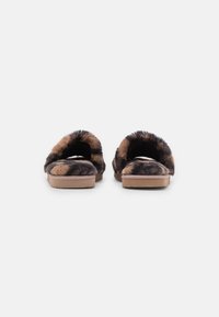Faux fur slippers with a brown and black pattern, open back design, soft texture, and a flat, tan sole.
