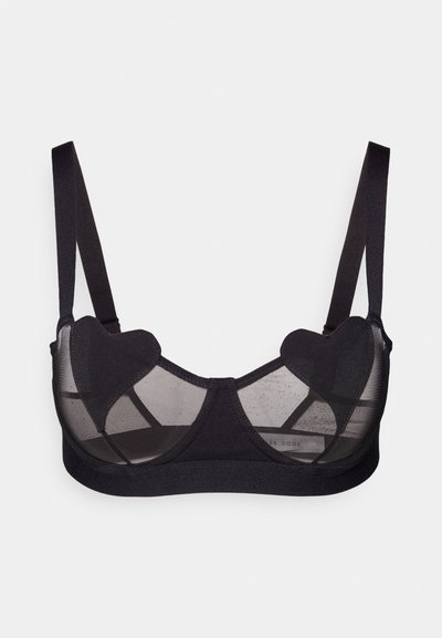 Čierna podprsenka s priehľadnými sieťovanými panelmi a akcentmi v tvare srdca. Nastaviteľné ramienka, kombinácia hladkej a textúrovanej tkaniny.