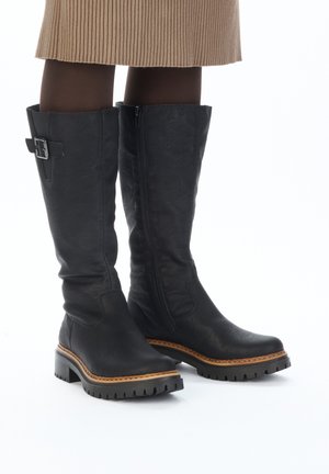 Black leather knee-high boots with a side zipper, buckle accent, textured finish, and a durable, rugged sole with a contrasting midsole.