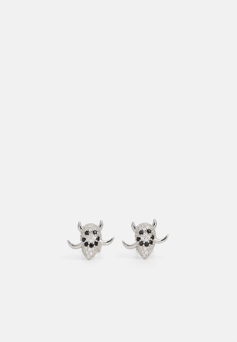 Silver-toned earrings shaped like bull heads, featuring black and white crystal embellishments and curved horns.