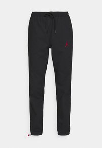 Schwarze Jogginghosen aus glattem Stoff, mit einem elastischen Bund und einem Kordelzug sowie einem roten gestickten Logo auf der linken Seite.