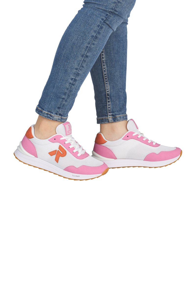 White and pink athletic shoes with mesh fabric, pink suede accents, and white laces. Features orange branding and a rubber sole.