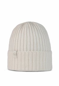 Cream-colored ribbed knit beanie with folded cuff and small fabric tag on cuff's side.