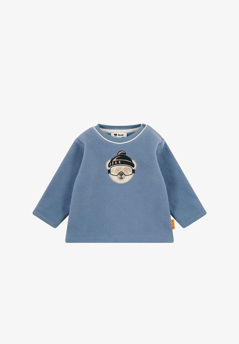 Modré fleecové tričko s dlouhým rukávem pro miminka, na kterém je vyšité medvědí, který nosí zimní čepici a lyžařské brýle, na hrudi.