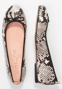 Ballet flats with a black and white snake print pattern, textured synthetic upper, soft pink insole, and a thin black trim around the opening.