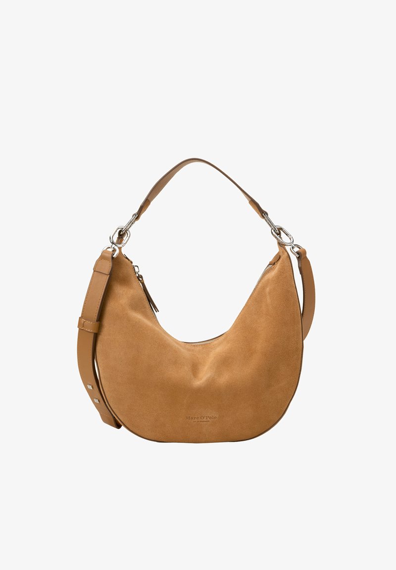 Tan suede hobo bag with a curved shape, adjustable leather strap, silver hardware, and a zip closure at the top. Soft texture, minimal branding.