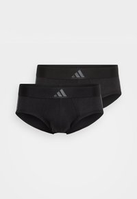Schwarze Baumwoll-Boxershorts mit glatter Textur und elastischem Bund, der ein dezentes graues Logo trägt. Zwei Paare sind übereinander geschichtet.