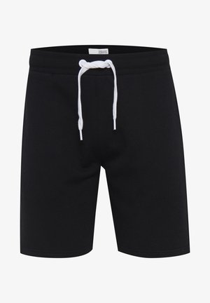 Shorts noirs en tissu doux, dotés d'une fermeture à cordon blanc. Le design est simple, sans poches ni motifs.