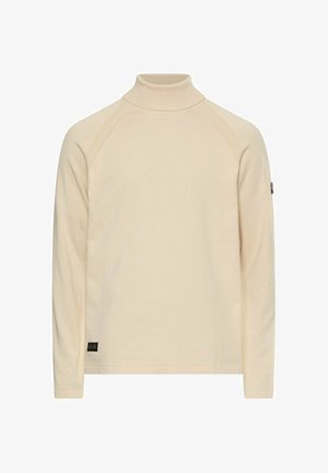 Beżowa bluzka z długim rękawem i kołnierzem typu golf, z ryflowanymi szwami na ramionach, małą metką z logo blisko dołu oraz naszywką na lewym rękawie.