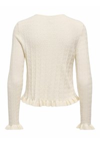 Krémově zbarvený pletený svetr s dlouhými rukávy, texturovaným cikcak vzorem a volánkovými okraji na manžetách a spodním lemu.