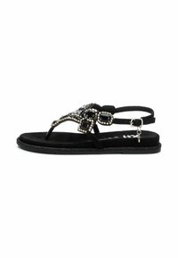 Sandalo in suede nero con decorazioni in strass, cinturino alla caviglia regolabile, suola piatta e design a T. Texture liscia e stile minimalista.