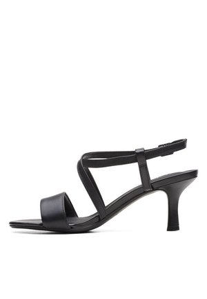 Black leather heeled sandal featuring wide front strap, crisscross ankle straps, and a slim heel. Smooth texture with a minimalist design.