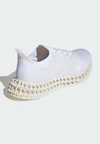 White athletic shoe with a textured upper, three white side stripes, and a unique lattice-like sole for comfort and support.