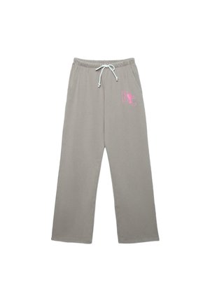 Svetlosivé teplákové nohavice s bielym sťahovacím šnúrkou a ružovým nápisom "NYC" na hornej ľavej stehnej časti, s bočnými vreckami a širokými nohavicami.