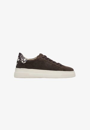 Brown suede sneaker with white rubber sole, round toe, and contrasting patterned heel detail. Includes lace-up closure and branding.