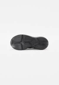 Sole de pantof sport negru, cu un model texturat, realizat din material de cauciuc. Design conturat cu un profil în formă de val pentru aderență și stabilitate.