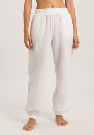 White, lightweight, loose-fitting pants made of soft fabric, featuring an elastic waistband and gathered cuffs at the ankles.