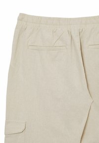 Pantaloni in lino beige chiaro con vita elastica, due tasche posteriori e una tasca laterale. Tessuto morbido con vestibilità rilassata.