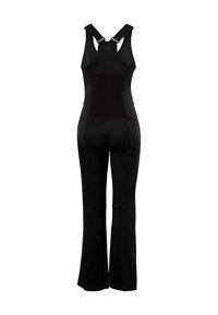 Sort atletisk jumpsuit med justerbare stropper, flagrende ben, tekstureret rygpanel og lynlåsdetaljer ved ærmerne. Elegant, tætsiddende design.