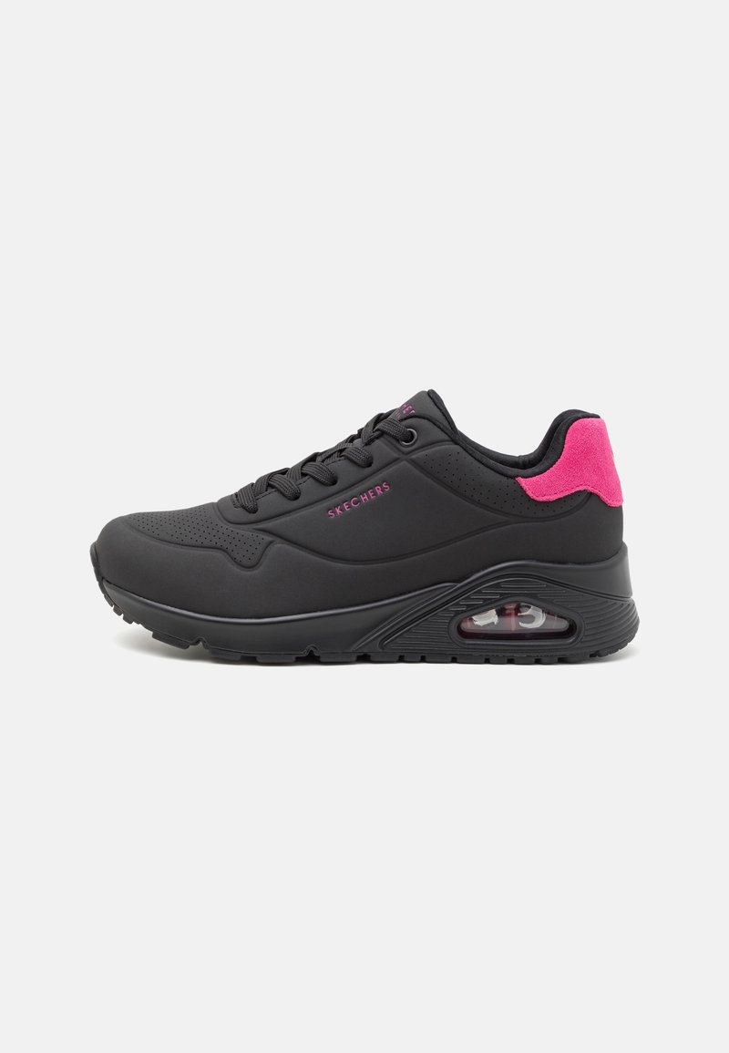 Black athletic shoe with pink accents, featuring a synthetic upper, lace-up design, and visible air cushioning in the sole.
