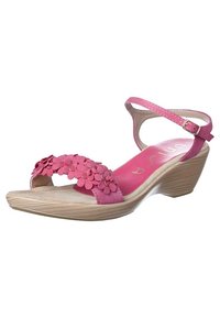 Pink wedge sandal with floral embellishments on the strap, curved design, and a textured sole. Adjustable ankle strap for fit.