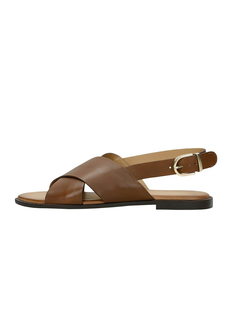 Brown leather sandal featuring crisscross straps, an open toe, a back strap with a metal buckle, and a flat black sole.