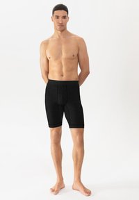 Schwarze, enganliegende Shorts mit einem strukturierten Bund und kontrastierenden Einsätzen, aus weichem, elastischem Material, knielang mit glatten Kanten.