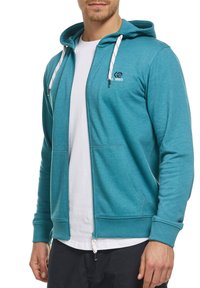 Hoodie bleu zippé avec cordons de serrage, deux poches avant, poignets côtelés et un logo sur la poitrine. Fabriqué à partir d'un tissu texturé et confortable.
