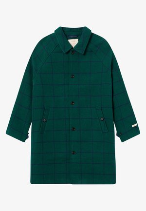 Grüner Wollmantel mit nautischem Karomuster, fünfknöpfiger Verschluss, zwei Seiten Taschen und einem spitzen Kragen. Raglanärmel mit einer lockeren Passform.