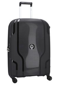 Valigia rigida nera con superficie in rete testurizzata, maniglia telescopica argentata, quattro ruote e logo sulla parte anteriore.