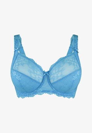 Reggiseno in pizzo blu chiaro con coppe trasparenti, bordi scallop e fiocchi decorativi sulle spalline, caratterizzato da motivi floreali e tessuto testurizzato.