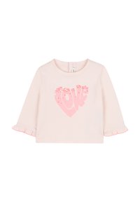 Camicia a maniche lunghe rosa chiaro con orlo arricciato, adornata da una grafica a forma di cuore in paillettes rosa che riporta la scritta "love". Materiale morbido in cotone.