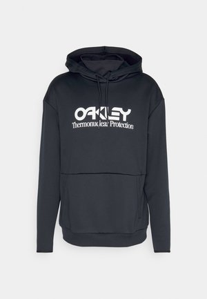 Mustapaita, jossa on kengurupussi, naruhuppu ja valkoinen logo-teksti "OAKLEY Thermonuclear Protection" etupuolella.