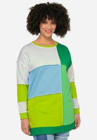 Camisa de manga larga con un diseño de patchwork en azul claro, verde y blanco, con cuello redondo y puños acanalados.