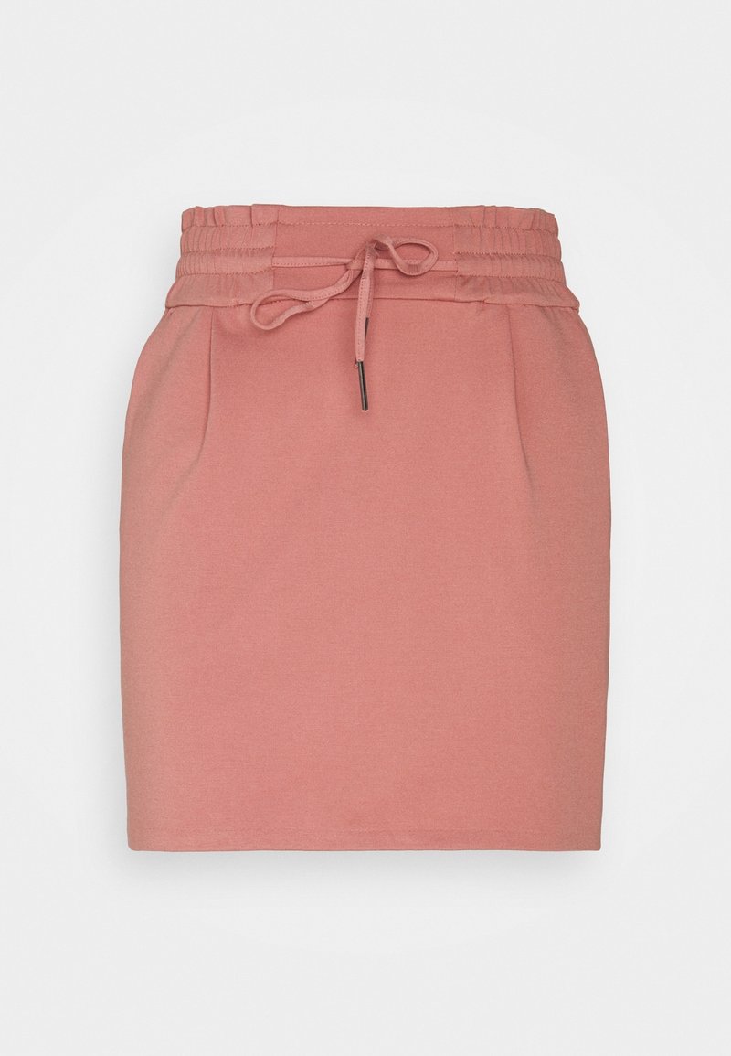 Jupe rose poudré longueur genou avec taille élastique et lien à nouer, présentant des plis discrets à l'avant et une coupe droite.