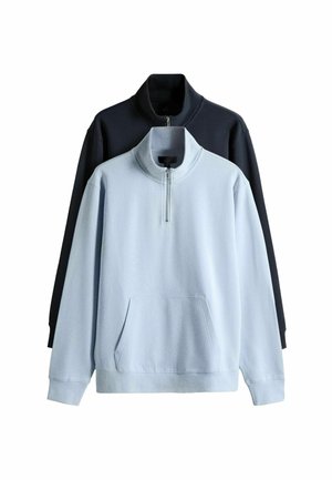 Two fleece pullovers with half-zip collars and front pockets, one in light blue in front and one in black behind.