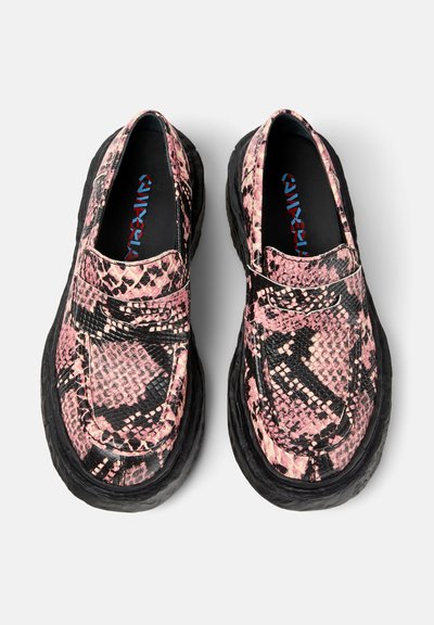 Pink and black snake-print slip-on shoes with textured leather upper and thick black rubber sole, featuring a low-profile design.