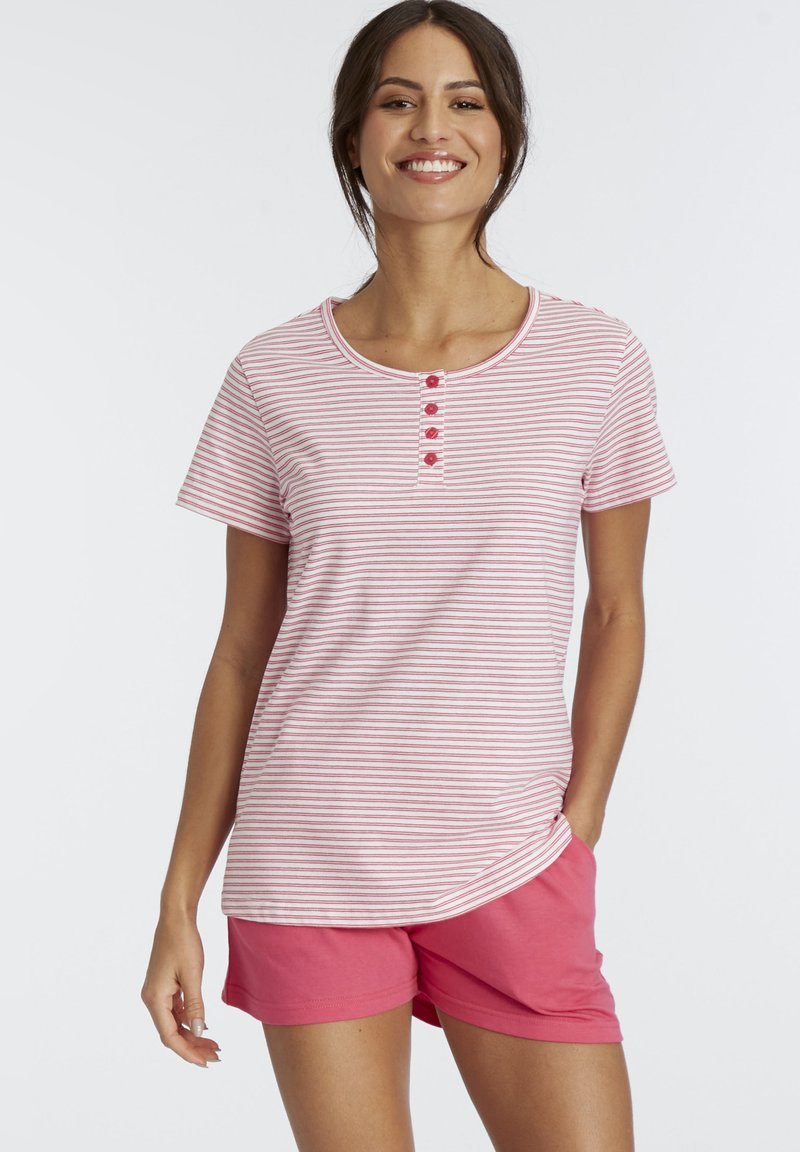 Pink and white striped T-shirt with a rounded neckline and four buttons; paired with solid pink shorts made from soft fabric.