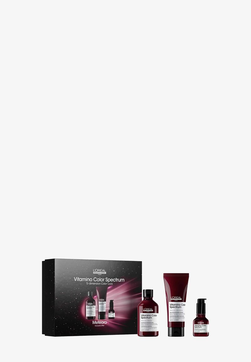 Zestaw L’Oréal Vitamino Color Spectrum składający się z trzech burgundowych butelek i kremu, zapakowany w czarne pudełko z kolorowymi kosmicznymi grafikami.