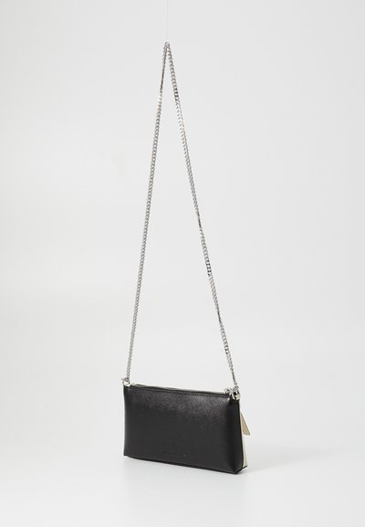 Svart rektangulær crossbody-veske med sølvkjede og glidelås, vist mot en enkel hvit bakgrunn.
