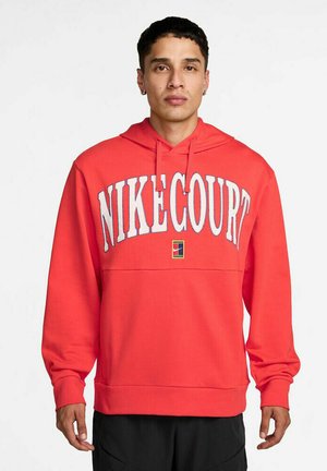 Red sweatshirt with a hood, featuring "NIKECOURT" in white lettering and a small colored logo patch on the front. Ribbed cuffs and hem.