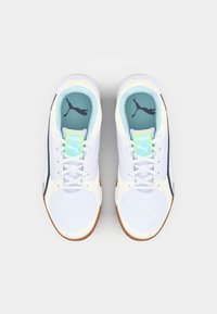 White athletic shoes with a textured design, featuring a light blue insole, white laces, and a gum outsole, accented with a blue logo.