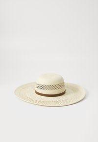 Beige Strohhut mit breiter Krempe und braunem Band. Besitzt ein gewebtes Design mit Lüftungslöchern für Atmungsaktivität. Flache, kreisförmige Form.