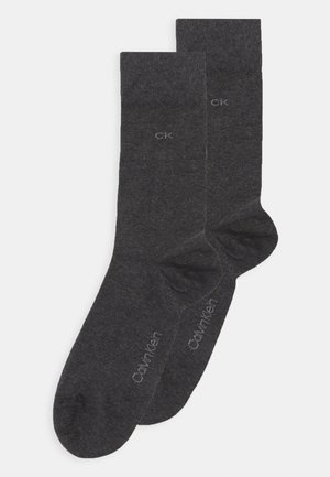 Graue Baumwollsocken mit einer glatten Textur, Logodetails und einem klassischen Design. Sie sind knöchellang und haben eine verstärkte Ferse.