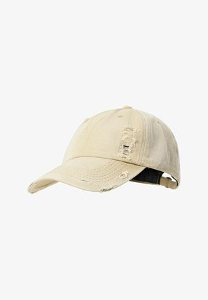 Beige distressed baseball cap with frayed holes on the front and top, featuring an adjustable strap at the back.